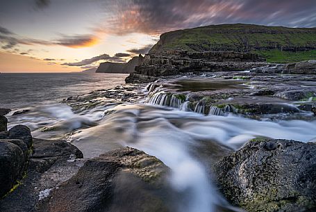 The Bsdalafossur waterfall flows from the Leitisvatn lake on the island of Vagar. This waterfall, like many others in the archipelago, falls directly into the Atlantic ocean., Faeroe islands, Denmark, Europe